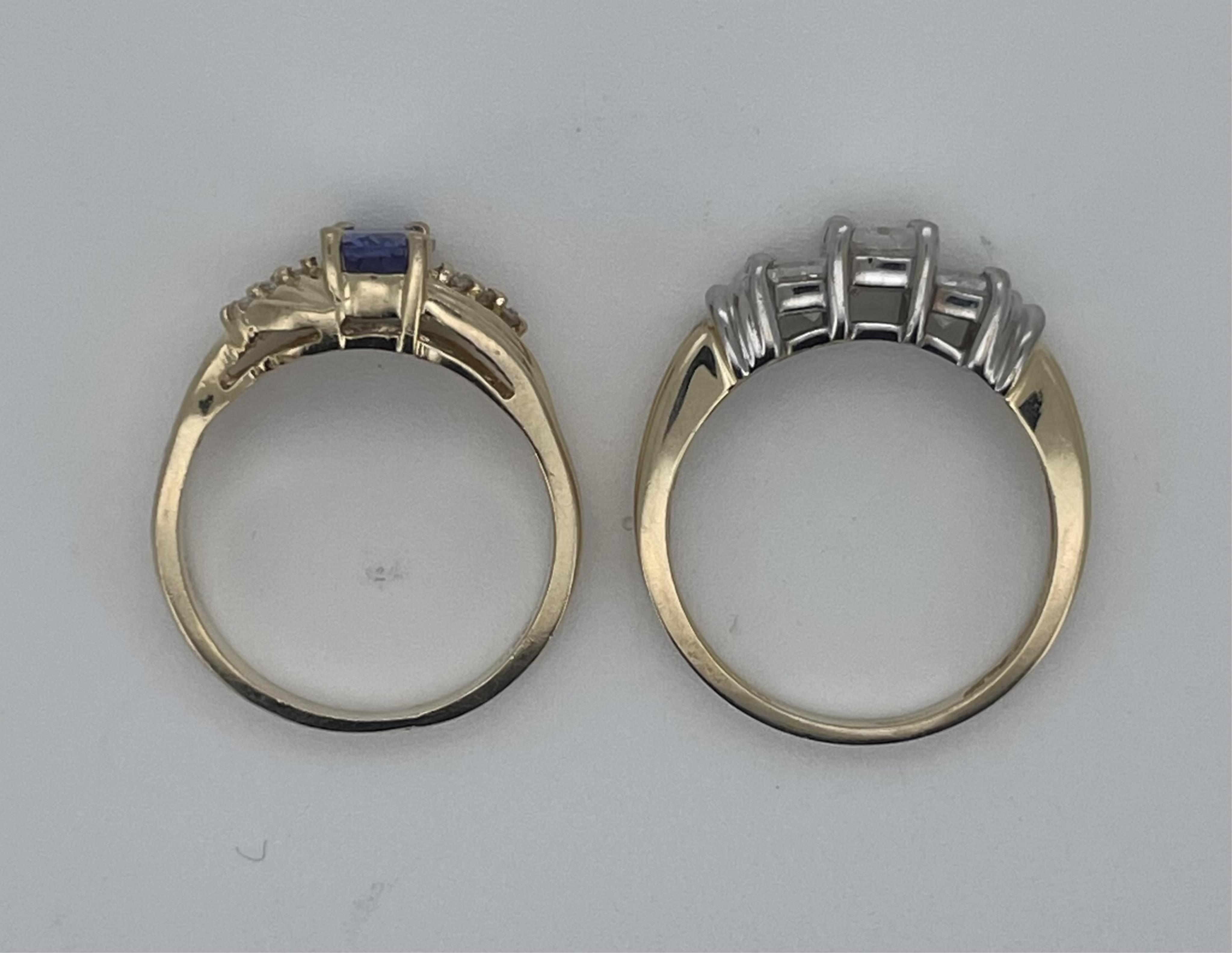 A modern 14ct gold and three stone Princess cut diamond set ring, size N, together with a 14k yellow metal and single stone oval cut tanzanite ring, with six stone diamond chip set shoulders, size M, gross weight 6.5 gra